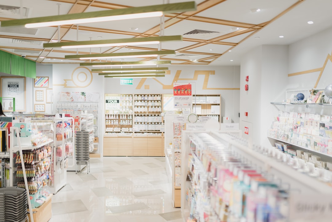 A bright stationery store interior with shelves of greeting cards and office supplies